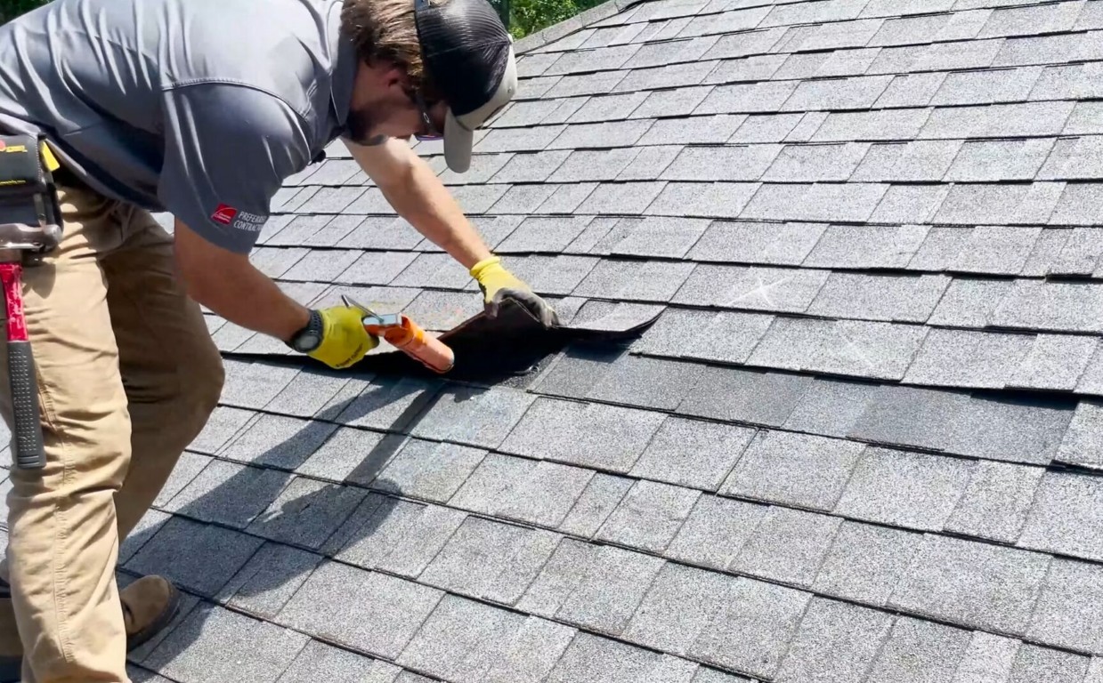 Professional roof repair contractor fixing shingles in Calexico, CA